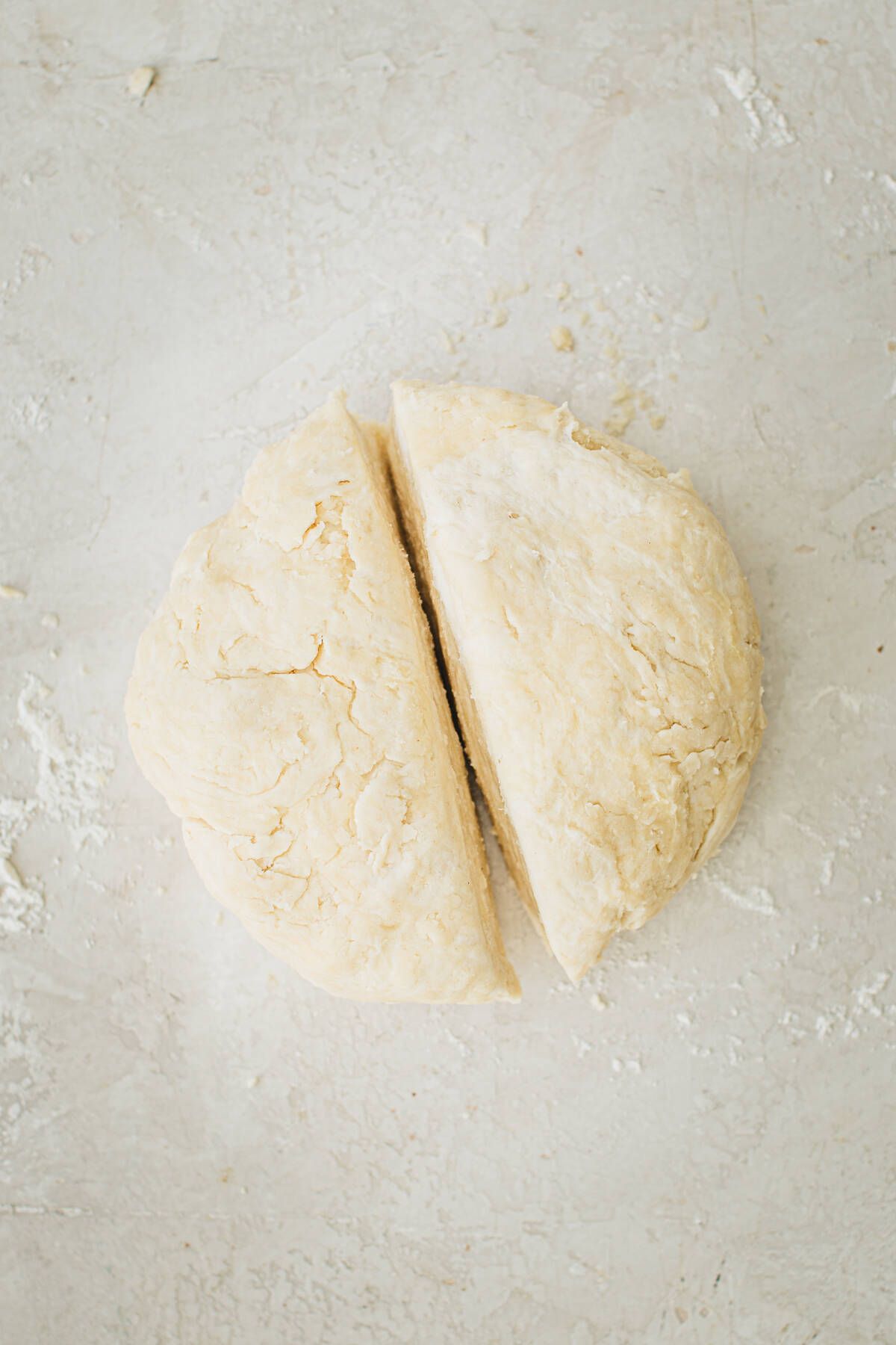 Pie dough cut in half for making two pie crusts.