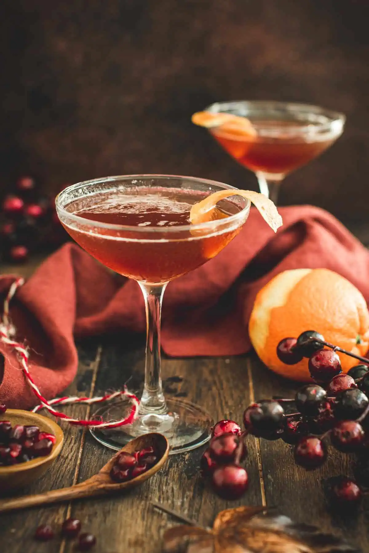 Pomegranate Martini with an orange peel for garnish.