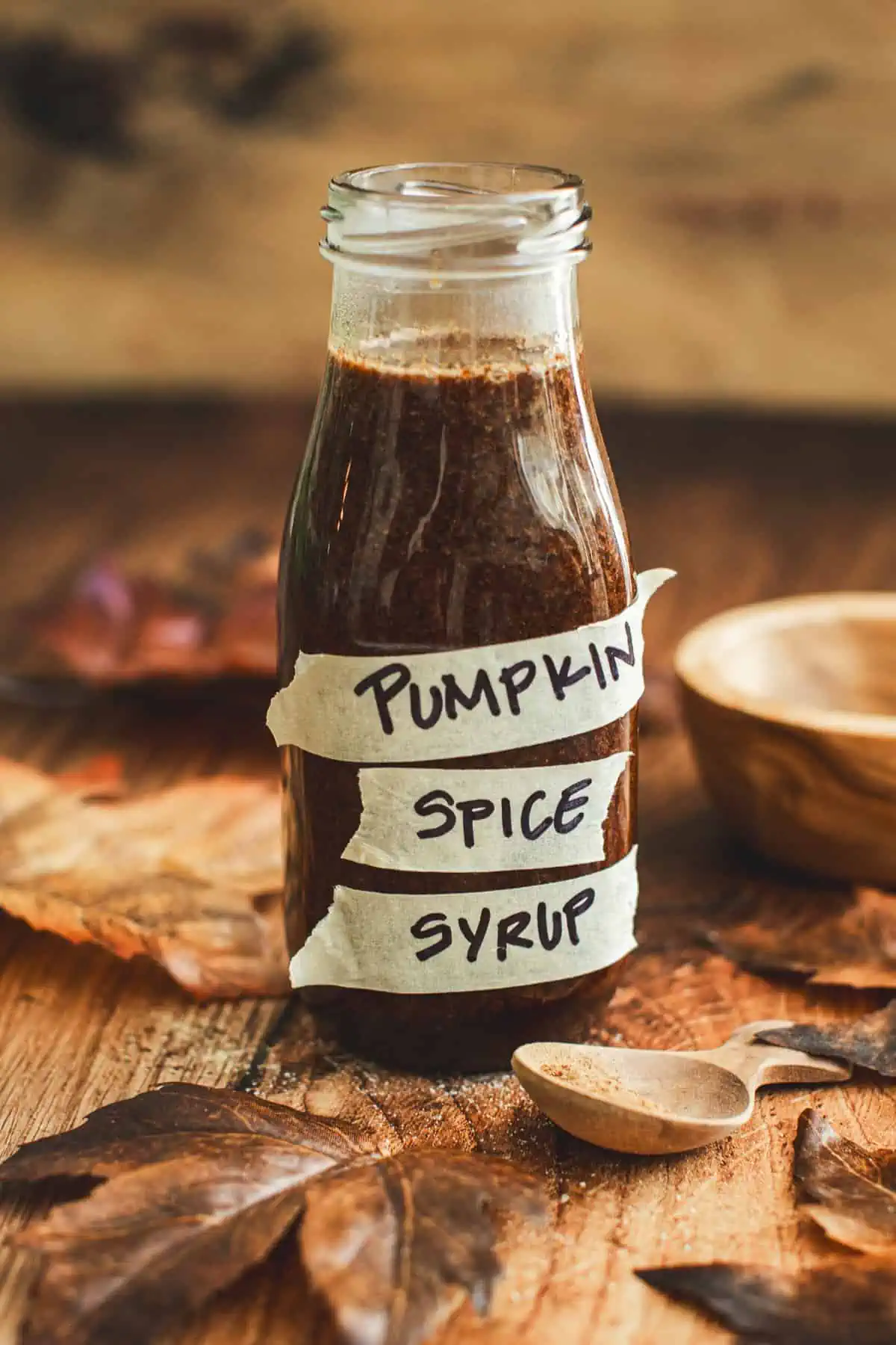 Pumpkin spice syrup in a bottle with a label that says "pumpkin spice syrup".