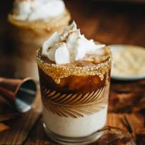 Pumpkin Spice White Russian with a graham cracker rim and topped with whipped cream.