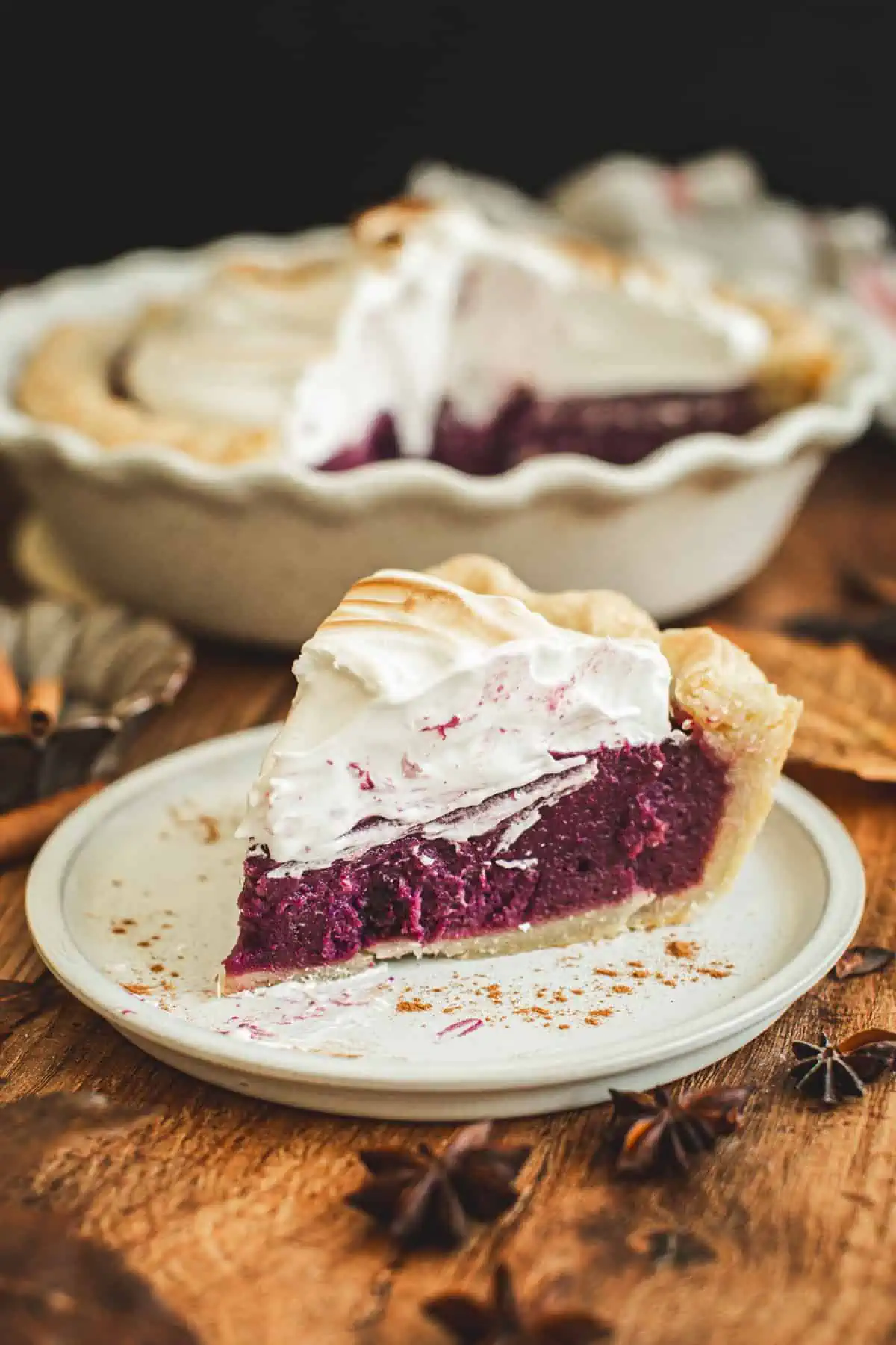 Slice of purple sweet potato pie with marshmallow meringue topping.