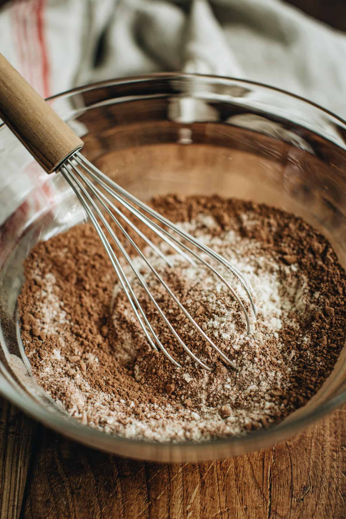 Dry ingredients for making turtle cookies in a mixing bowl with a whisk.