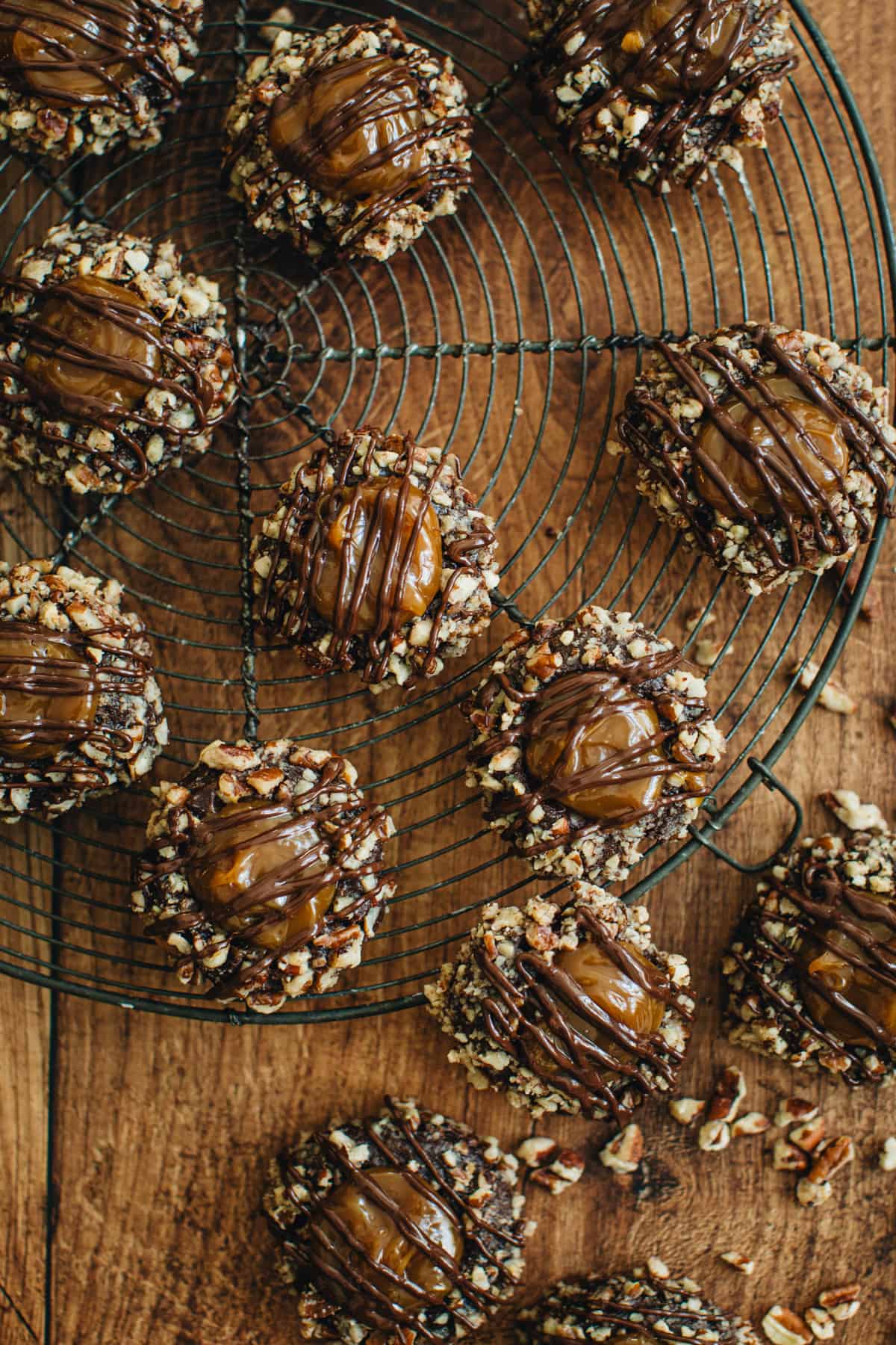 Turtle cookies sitting on a round wire rack.