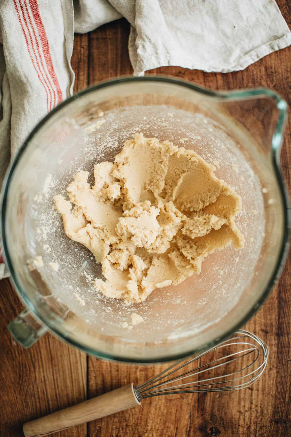 Creamed butter and sugar in the bowl of an electric mixer for making turtle cookies.