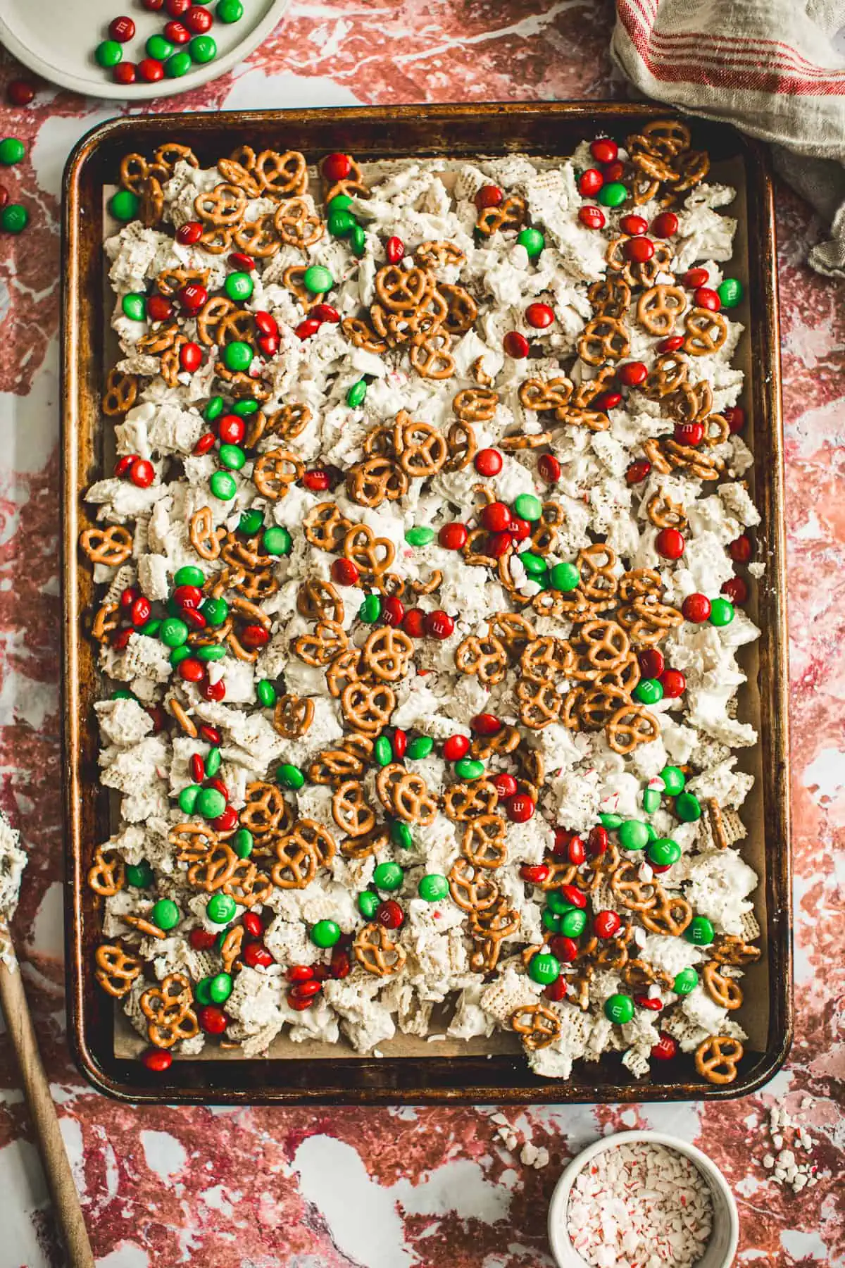 Christmas snack mix on a rimmed baking sheet.
