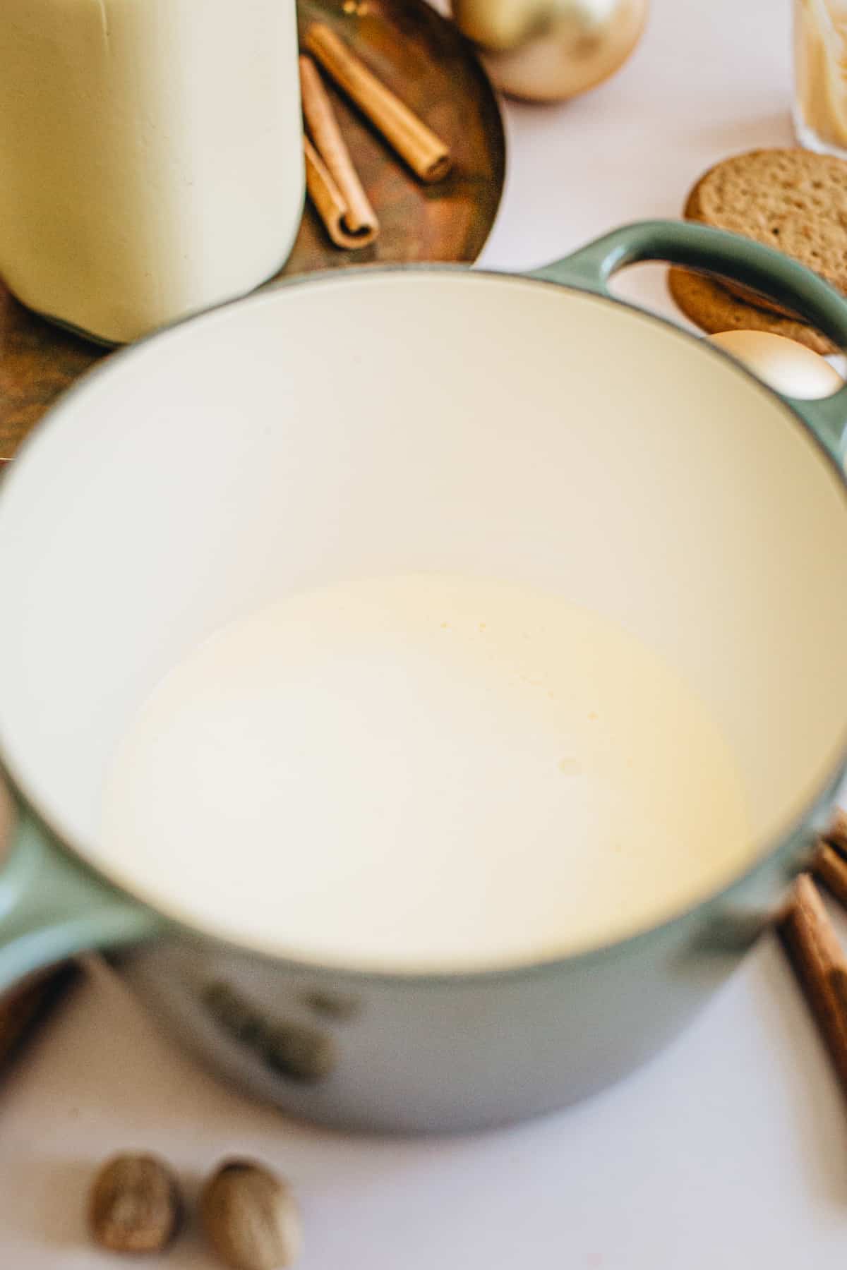 Eggnog and milk mixture in a saucepan ready to steam for making an eggnog latte.