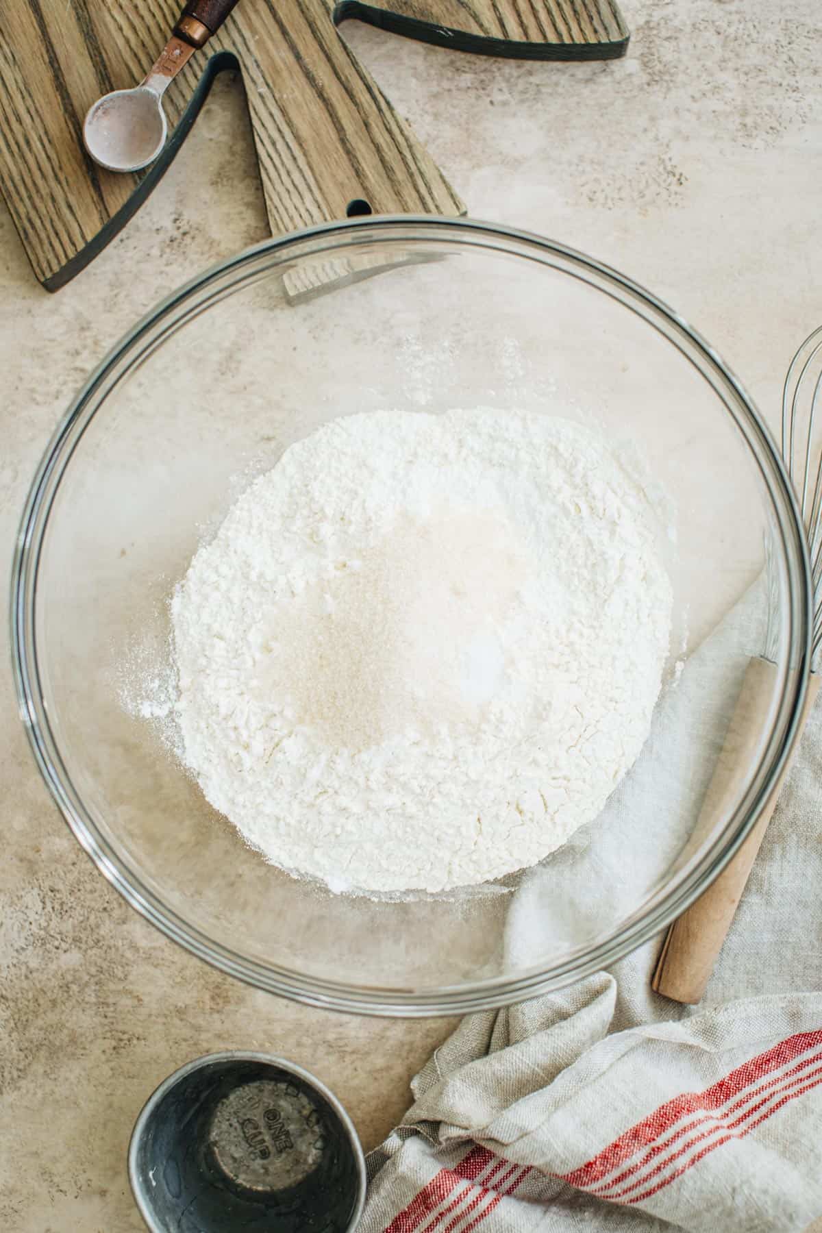 Flour, baking powder, salt, and sugar in a mixing bowl for making English scones.