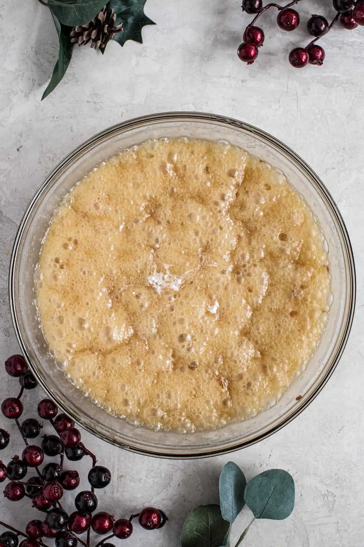 Bubbling peanut brittle mixture in a large mixing bowl.