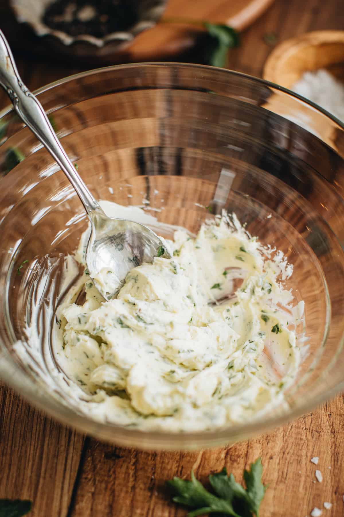 Herb butter in a mixing bowl with a spoon for making cast iron filet mignon.