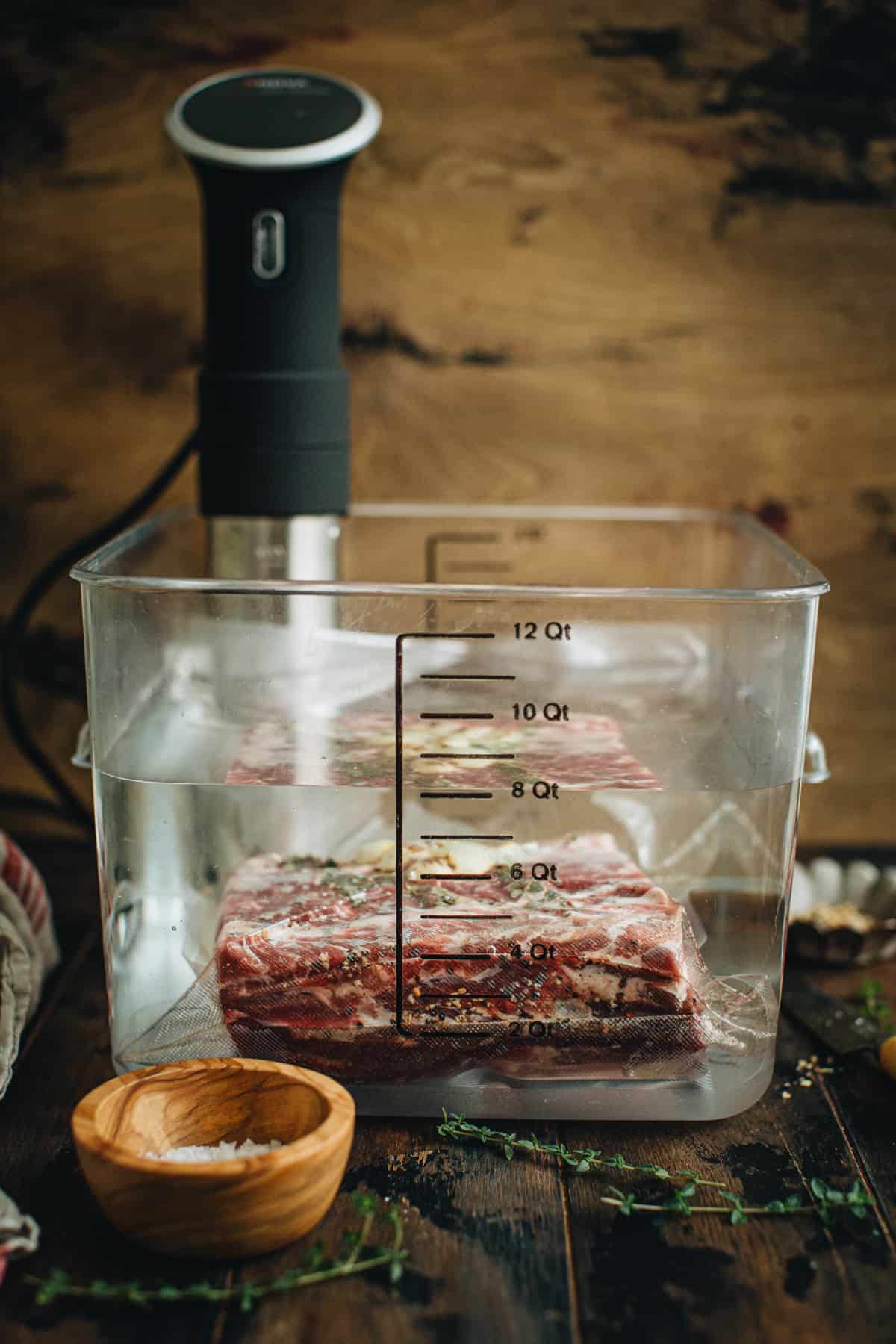 Prime rib roast in a sous vide water bath cooking.