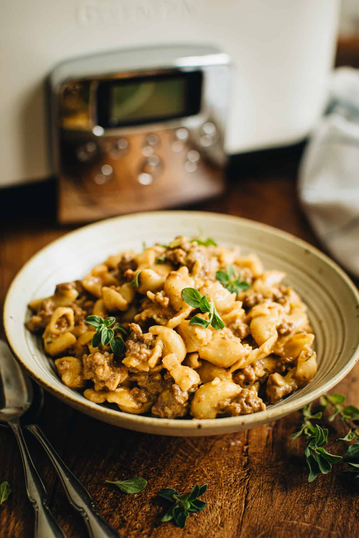 Crockpot Hamburger Helper in a bowl topped with fresh oregano.