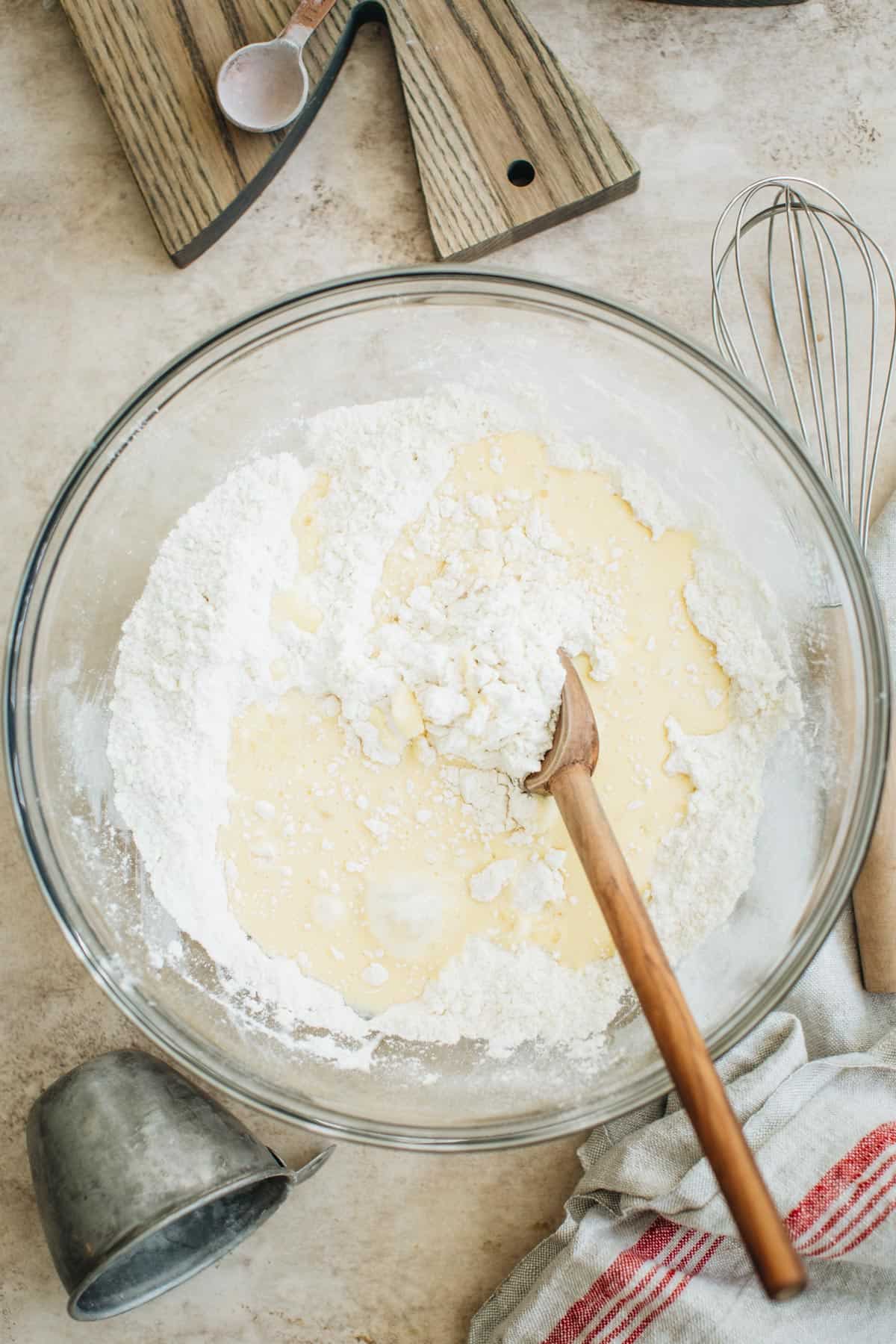 Using a wooden spoon to mix the dough for English scones.