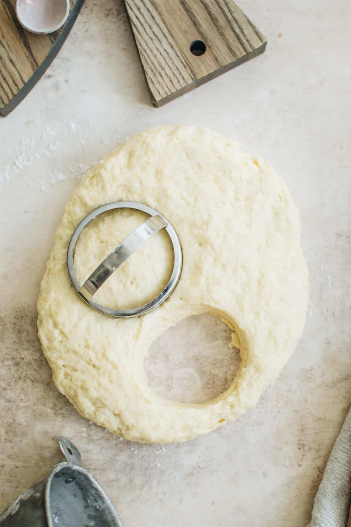 Using a biscuit cutter to cut the dough for making English scones.