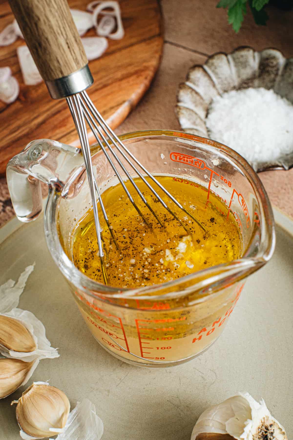 Dressing for Farro Salad in a measuring cup with a whisk.